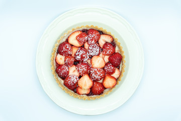 Strawberry tart shot in studio on white background