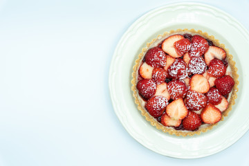 Strawberry tart shot in studio on white background