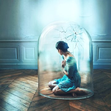 Woman sitting in glass cage