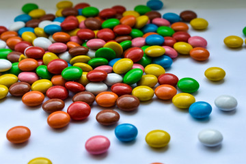 Round candies on a white background, scattered candies