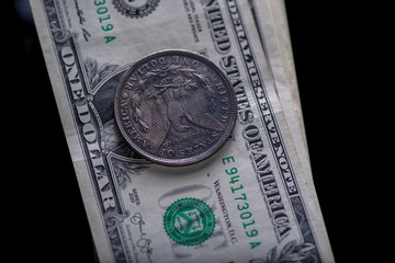 A bundle of banknotes of US dollars on a dark background. Photographed close-up.