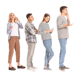 Obraz premium Young people waiting in line on white background