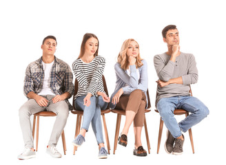Obraz premium Young people waiting in line on white background
