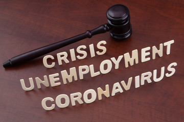 Unemployment and crisis because coronavirus pandemic concept. Judge gavel with words coronavirus, unemployment and crisis.