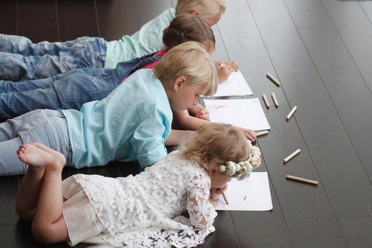Cute little children drawing at home