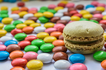 Fototapeta na wymiar Macaroni on a background of colorful candies