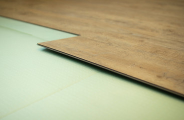 Fototapeta premium Vinyl laminate. Laying of the floor covering.