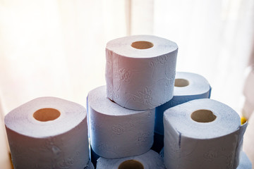 Lots of toilet paper rolls. Soft hygienic paper. Close up. Close up toilet paper roll pyramide. Concept of lack of toilet paper in stores due to coronavirus, Covid-19. Hygiene, panic.
