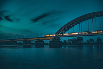 Train crossing bridge at night