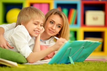 Obraz premium Mother with her son doing homework at home