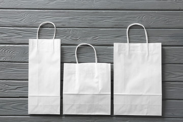 Paper shopping bags on wooden background