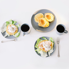 Healthy nutritious tasty breakfast. Pancakes, poached egg on ceramic plate and coffee cup. table setting. food photo. good morning