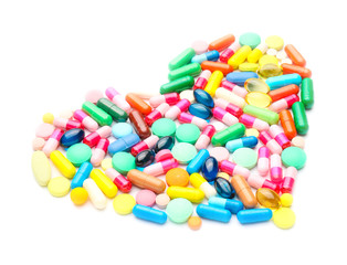 Heart made of pills on white background