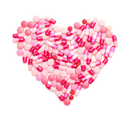 Heart made of pills on white background
