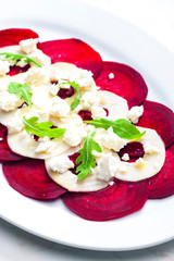 fresh beetroot and apple salad with fresh goat cheese and arugula