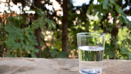 A glass with water on the nature background