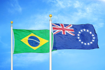 Brazil and Cook Islands two flags on flagpoles and blue cloudy sky