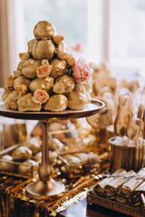 candy bar, sweets, sweets, chocolate, lollipops, cakes and macaroons are laid out on beautiful trays and decorated with flower arrangements