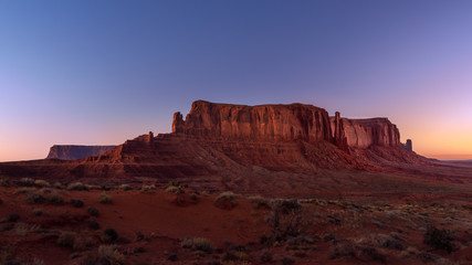 Collage with sunset and sunrise of the same place, view of Monument Valley on the border between Arizona and Utah, USA