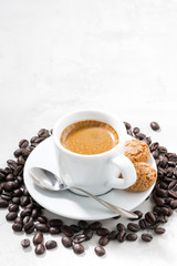 cup of fresh espresso and cookies on a white background, closeup vertical