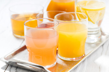 fresh citrus juices in glasses, closeup