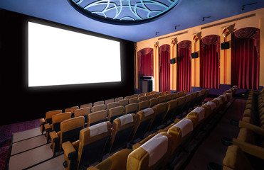 Cinema theater screen in front of seat rows in movie theater showing white screen projected from...