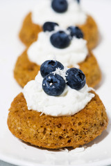 pumpkin cakes with cream and blueberries, vertical closeup