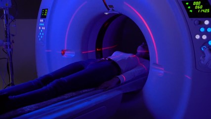 Computer diagnosis of the pelvis of a girl in a clinic with blue and red lasers. CT diagnostics of surgical and oncological pathologies, injuries, gynecological and urological diseases, vascular patho