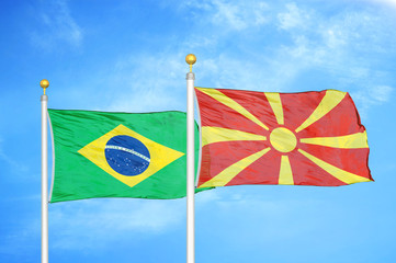 Brazil and North Macedonia two flags on flagpoles and blue cloudy sky