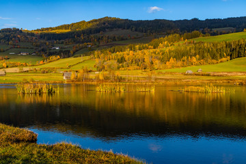 autumn pond under the mountains, Murau district,.Styria, Austria
