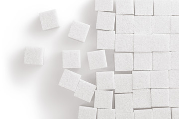 White sugar cubes on white background, top view