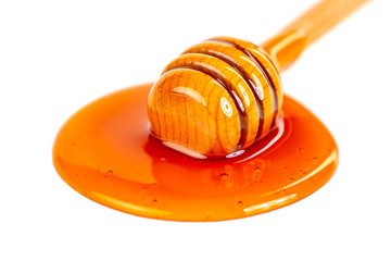 Honey with wooden dipper isolated on white background