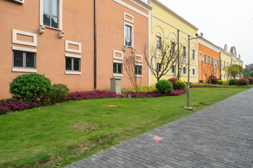 Grass and Mediterranean-style buildings in a shopping center