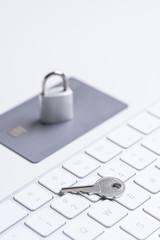 Finance. Security. Bank card with lock and key on a white table. Data security