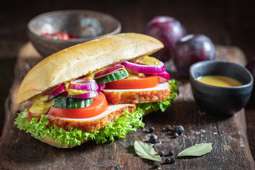 Tasty sandwich with roasted pork neck, cucumber and onion