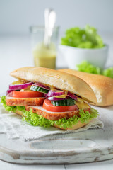 Savory sandwich made of pork neck with plums and vegetables