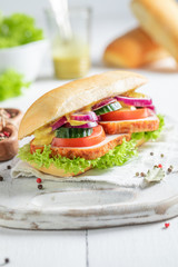 Homemade sandwich made of pork neck with plums and vegetables