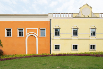 Grass and Mediterranean-style buildings in a shopping center