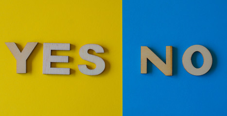 Yes or no, in wooden letters with yellow and blue background