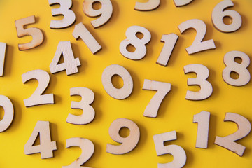 Set of wooden numbers on a yellow background