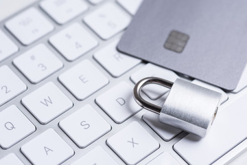 Finance. Security. Bank card with lock and key on a white table. Data security