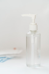 Antibacterial Hand Sanitizer Gel Blank Bottle Closeup Copy Space Vertical Photo. Container Antiseptic High Alcohol Liquid, Blurred Protective Gauze Dressing on Background. Coronavirus Covid-19 Disease