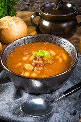 Beans with tomato sauce, bacon and sausage.