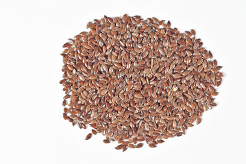 Texture of flax seeds. Many grains of flax on the pile. Flax on a white background.