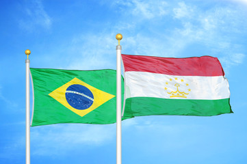 Brazil and Tajikistan two flags on flagpoles and blue cloudy sky