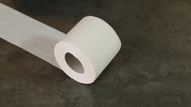 Toilet paper roll rolls on black background. close up