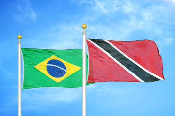 Brazil and Trinidad and Tobago two flags on flagpoles and blue cloudy sky