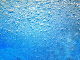 Water in the swimming pool is blue. Background. Details about water. Drops of water. Blurred. Shaded.