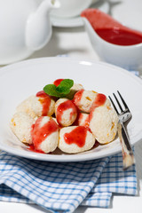 cottage cheese dessert with strawberry sauce, vertical