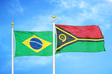 Brazil and Vanuatu two flags on flagpoles and blue cloudy sky